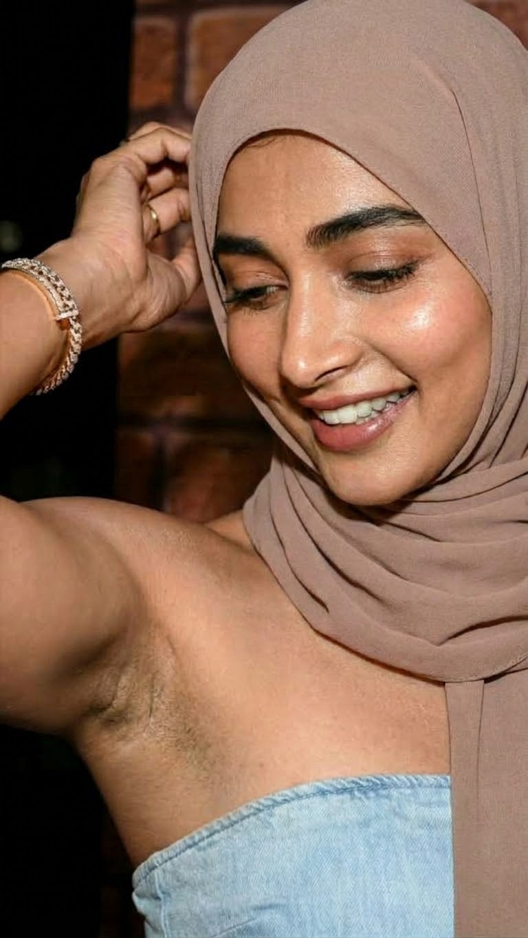Portrait with a beige headscarf and blue top.