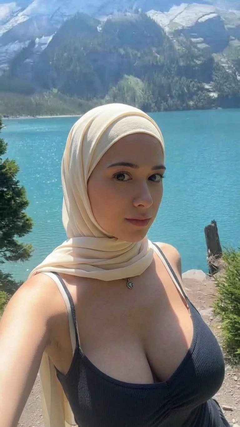 Portrait with a beige headscarf and black top.