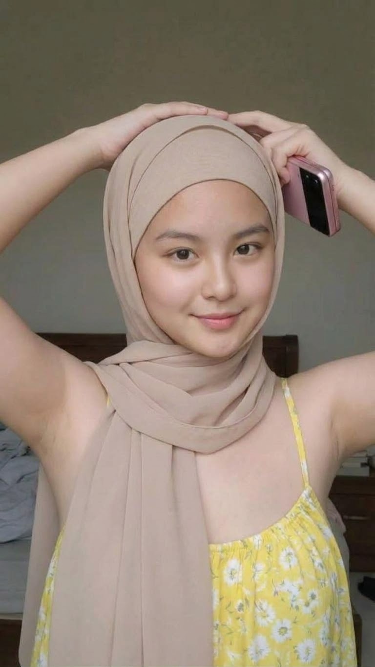 Portrait with a beige headscarf and yellow dress.