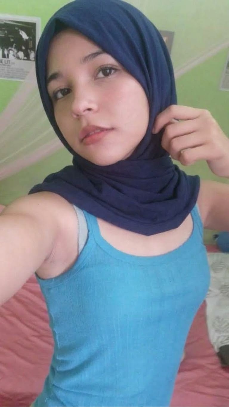 Portrait with a blue headscarf and blue top.