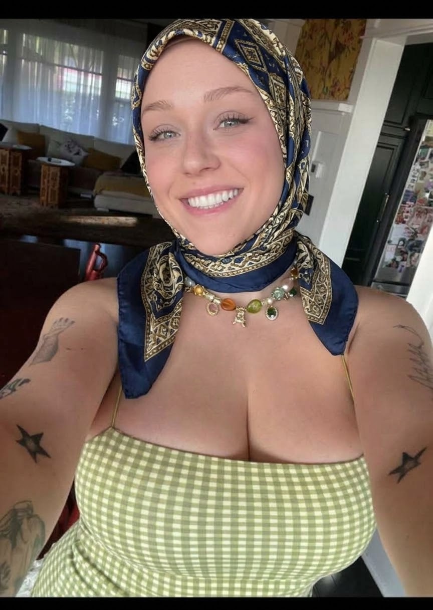 Portrait with a blue headscarf and green checked top.