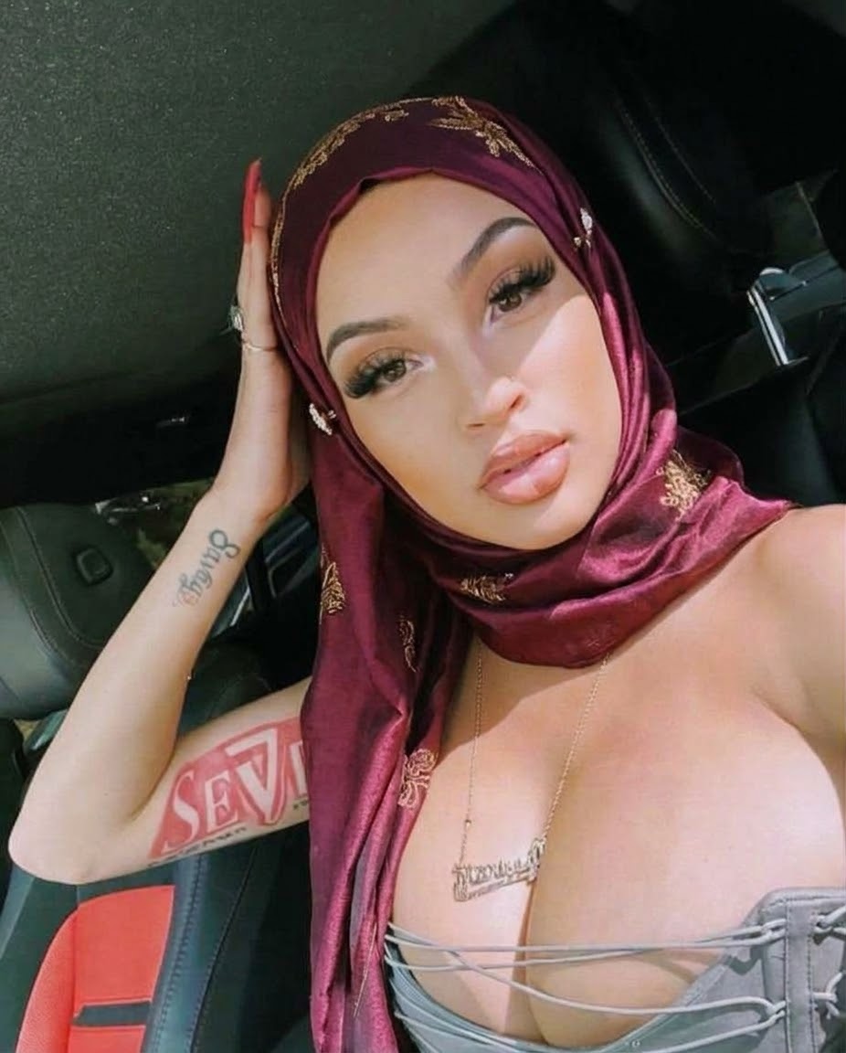 Portrait with a burgundy headscarf and pink top.