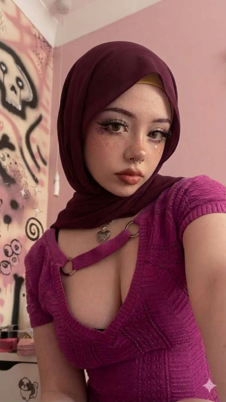 Portrait with a burgundy headscarf and purple top.