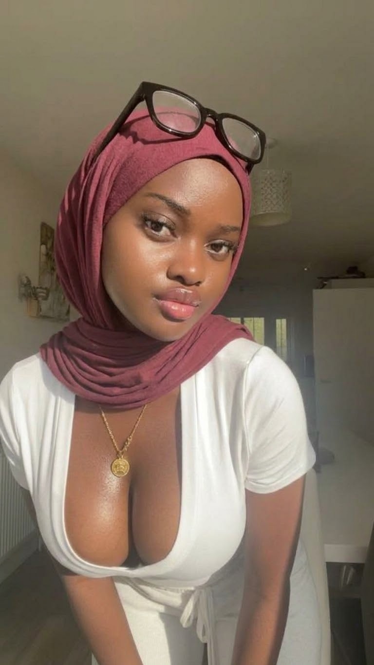 Portrait with a burgundy headscarf and white cardigan.