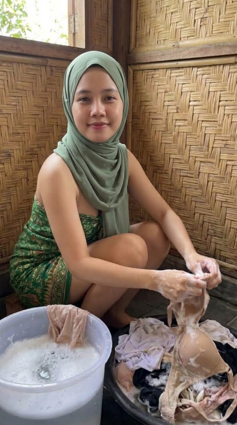 Portrait with a green headscarf and green top.