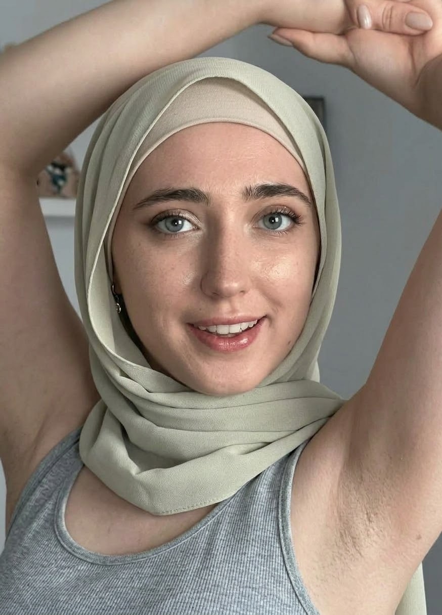 Portrait with a green headscarf and green top.