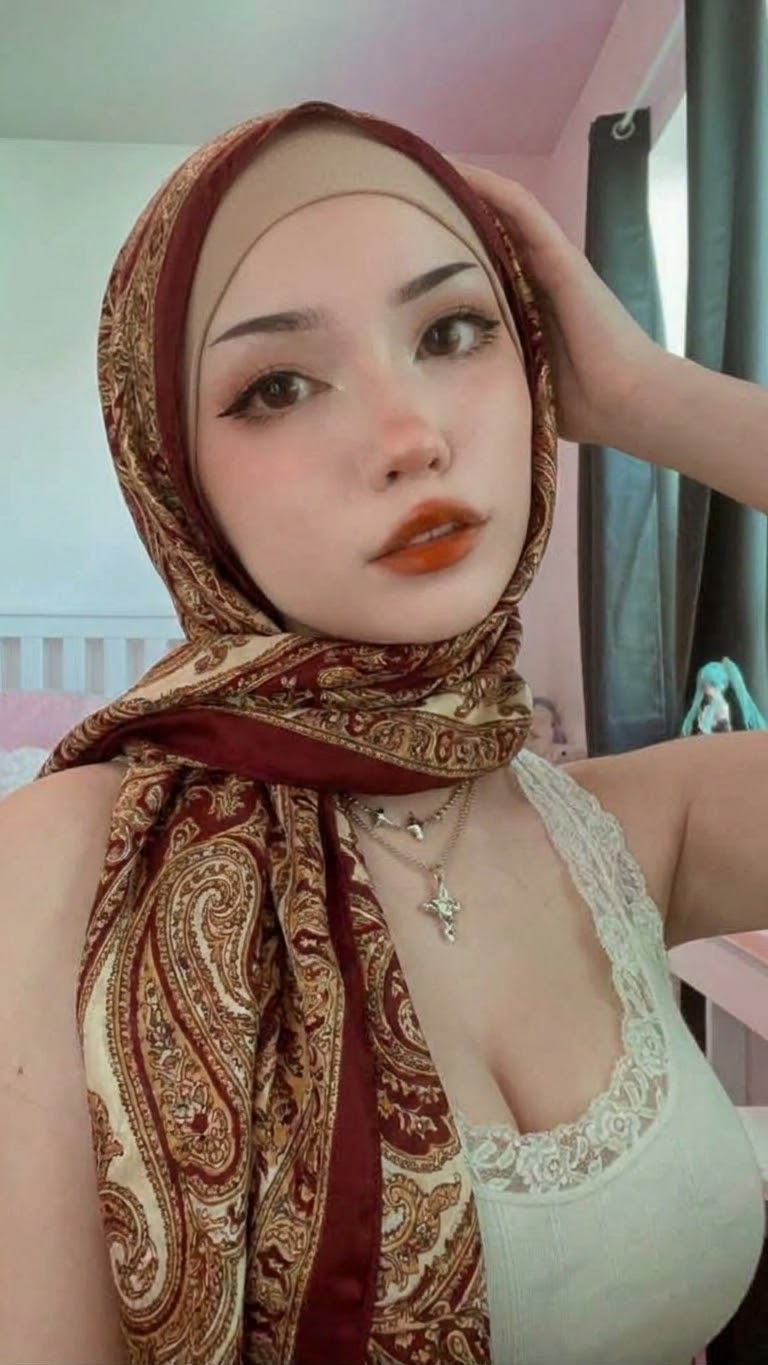 Portrait with a patterned headscarf and floral dress.