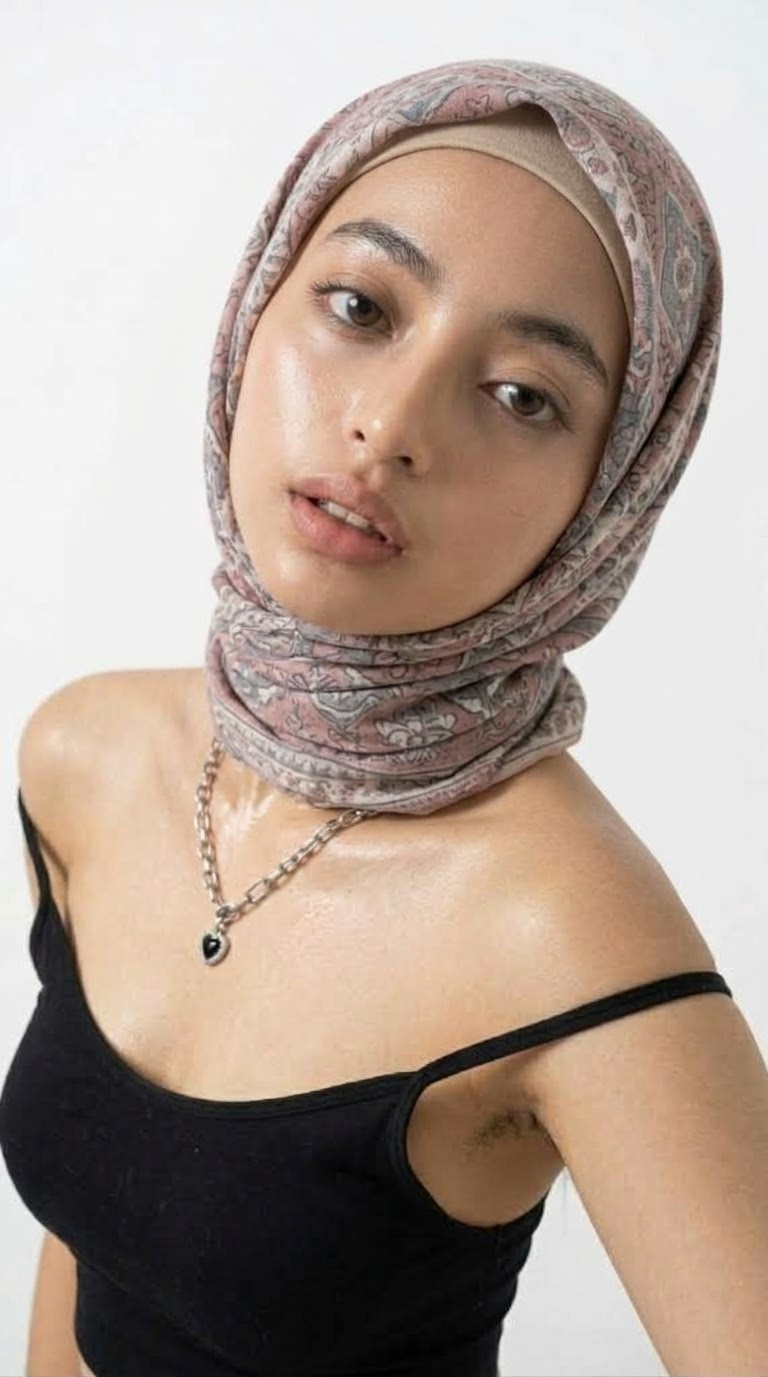 Portrait with a patterned headscarf and black top.