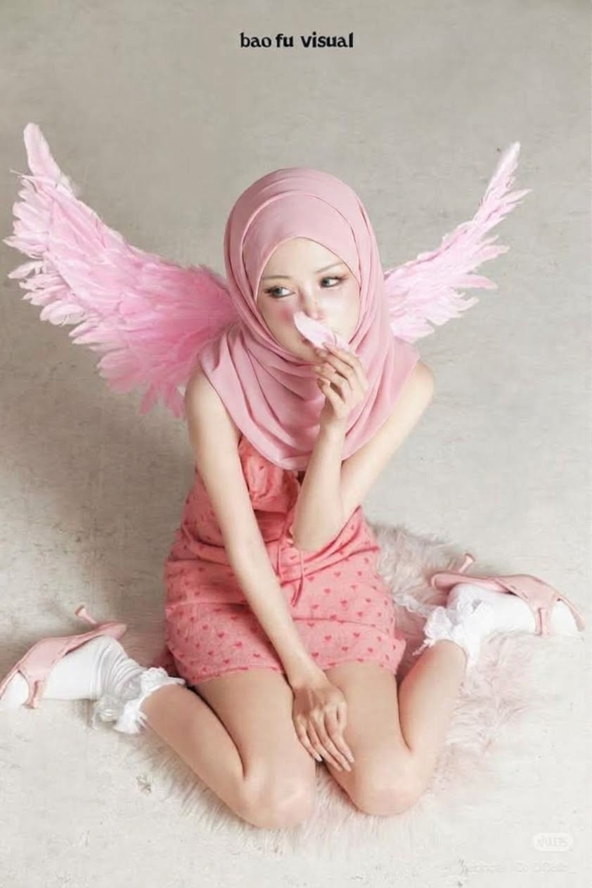 Portrait with a pink headscarf and winged costume.