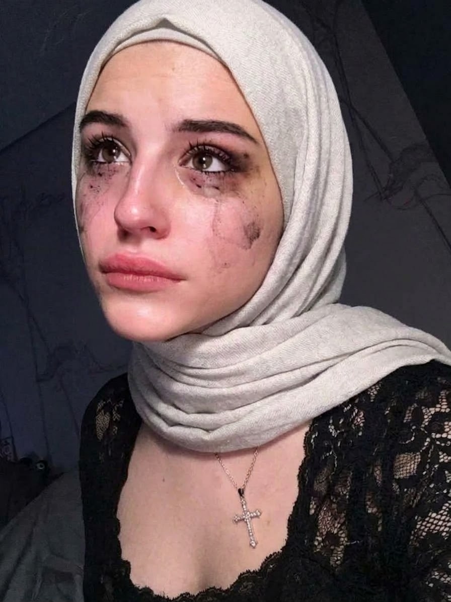 Portrait with a white headscarf and black lace top.