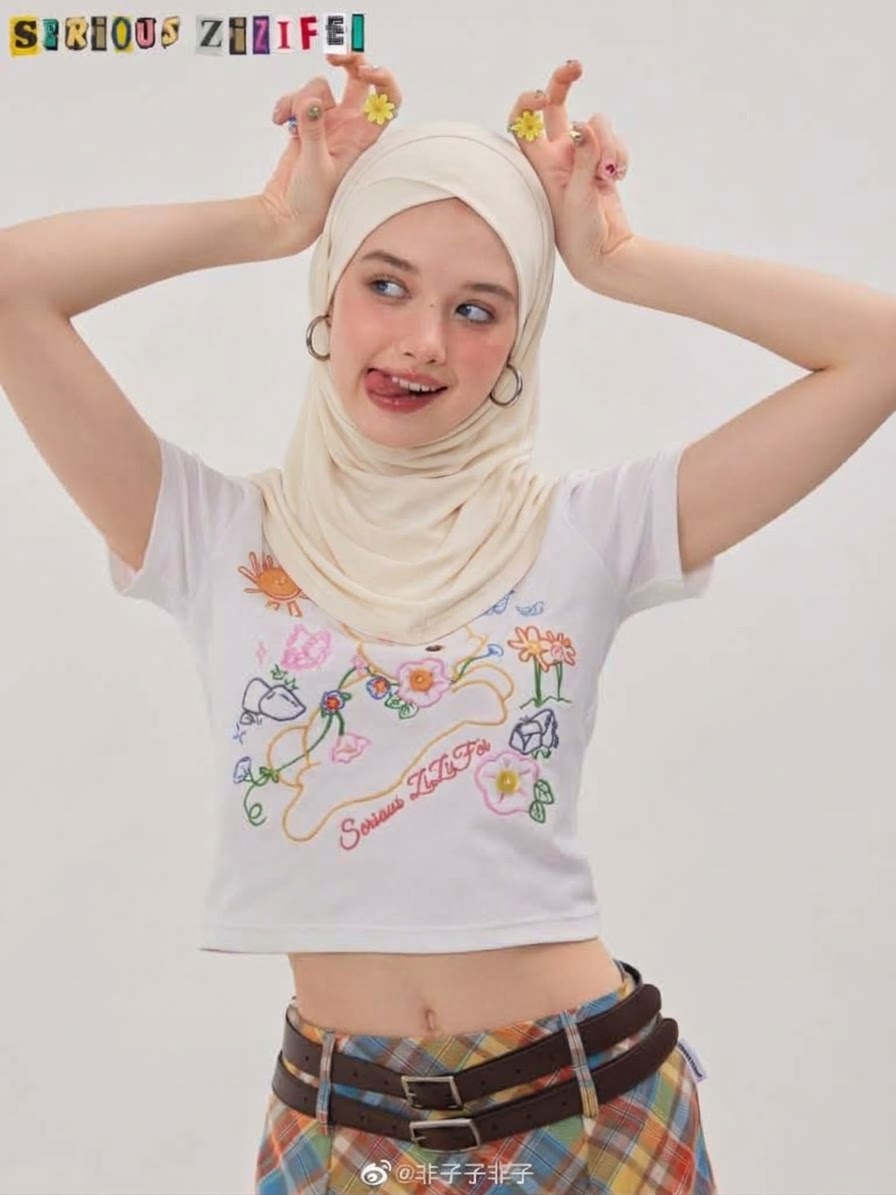 Portrait with a white headscarf and printed T-shirt.